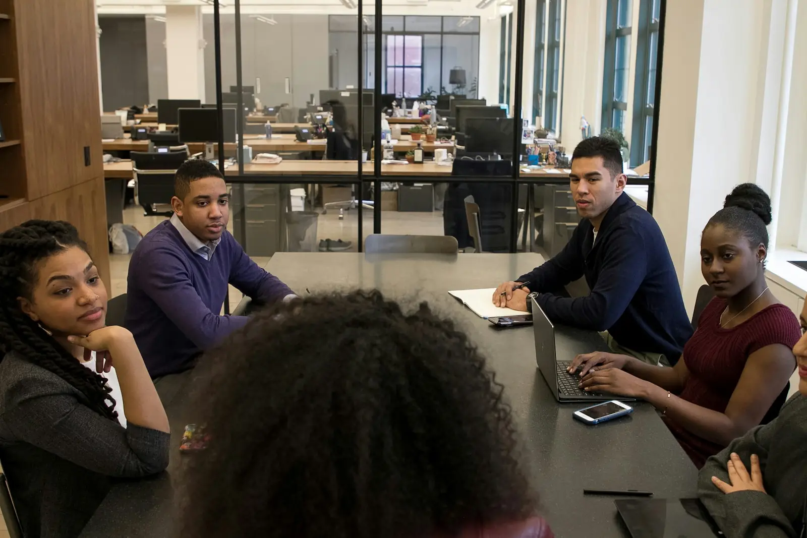A business team in discussion around a meeting table