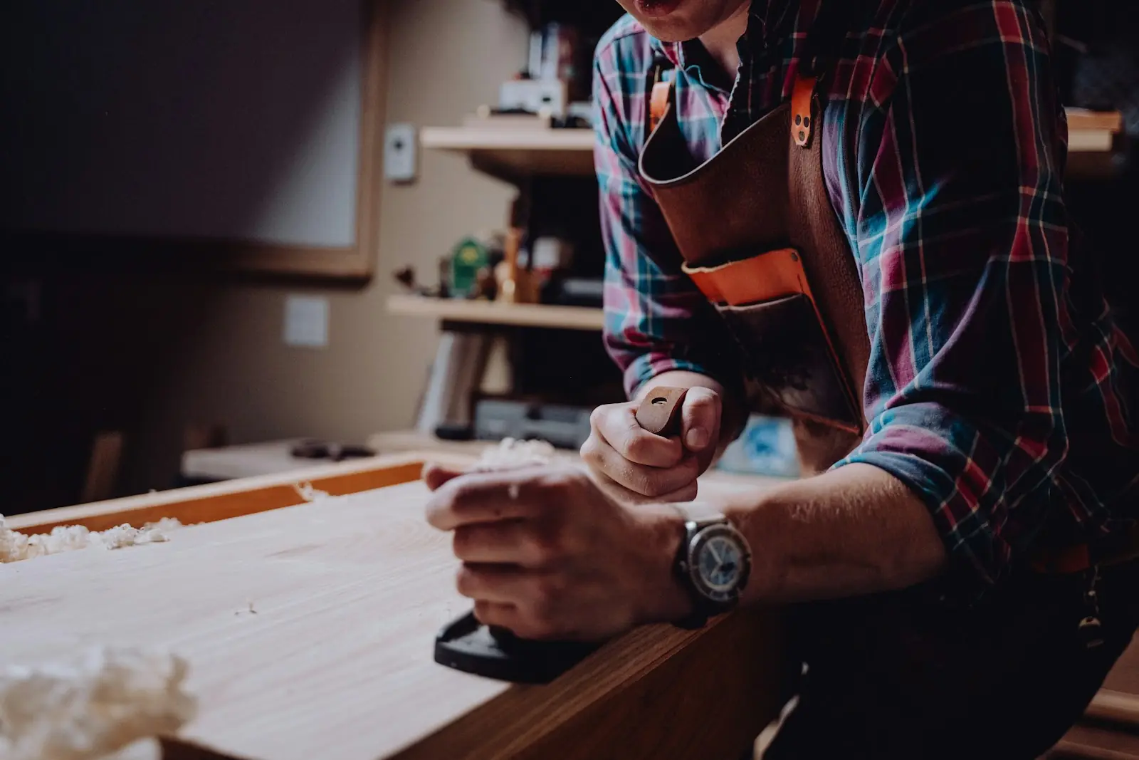 A craftsman shaping wood at his workbench